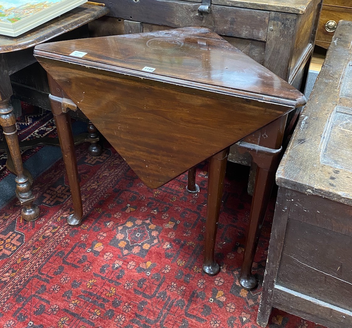 A 19th century triangular folding mahogany pad foot occasional table, width 79cm, depth 43cm, height 71cm